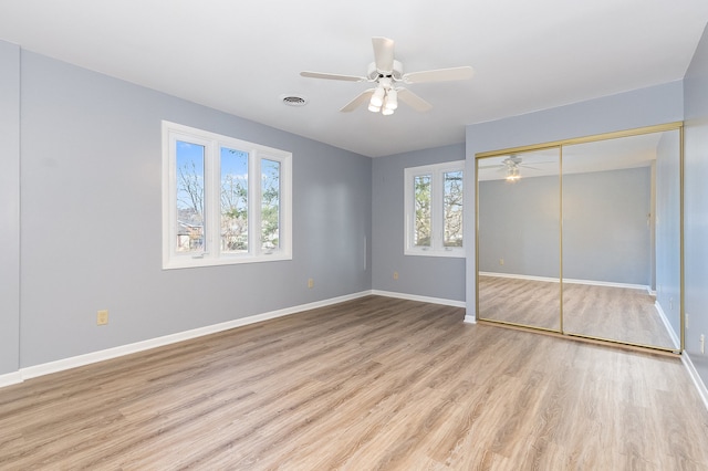 unfurnished bedroom featuring a closet, ceiling fan, and light hardwood / wood-style flooring