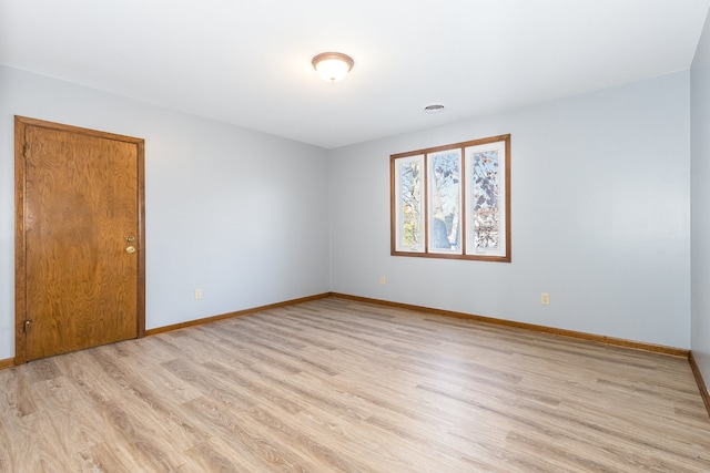 spare room with light hardwood / wood-style flooring