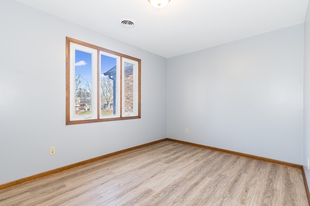 spare room featuring light hardwood / wood-style flooring