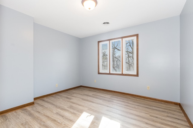 spare room featuring light hardwood / wood-style floors