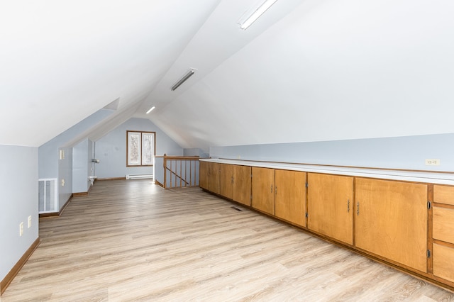 bonus room with light hardwood / wood-style flooring, a baseboard radiator, and lofted ceiling