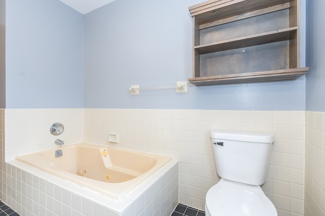 bathroom with tiled bath, tile patterned flooring, tile walls, and toilet