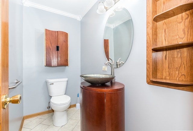 bathroom with tile patterned floors, toilet, vanity, and ornamental molding