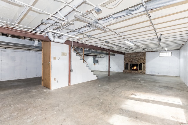 basement featuring a fireplace and electric panel