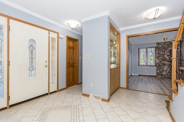 foyer entrance featuring light wood-type flooring and ornamental molding