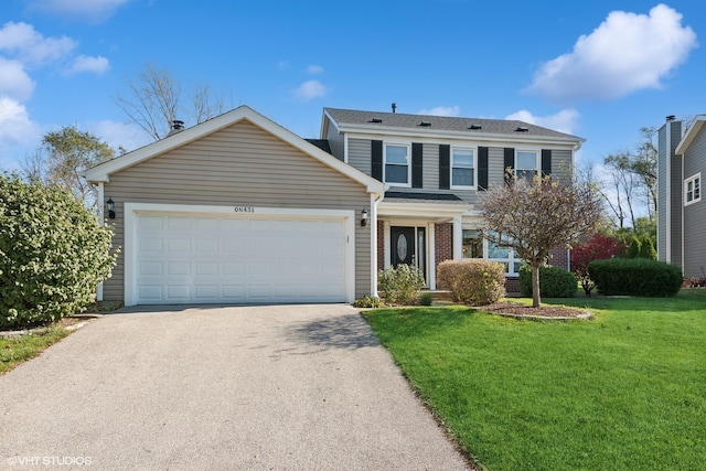 view of front of house with a garage and a front lawn