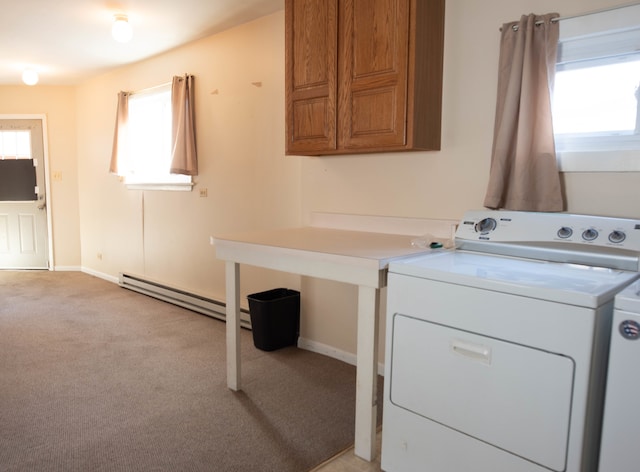 clothes washing area with light colored carpet, baseboard heating, and independent washer and dryer