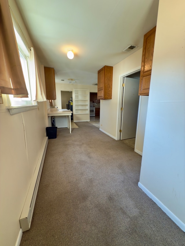 interior space featuring light carpet and a baseboard radiator