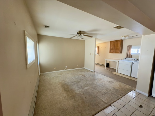 unfurnished living room with light carpet, ceiling fan, and washing machine and clothes dryer