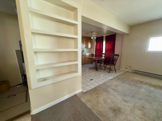 unfurnished dining area with light colored carpet, ceiling fan, and a baseboard heating unit