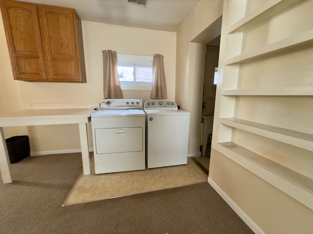 clothes washing area featuring washing machine and clothes dryer and light colored carpet