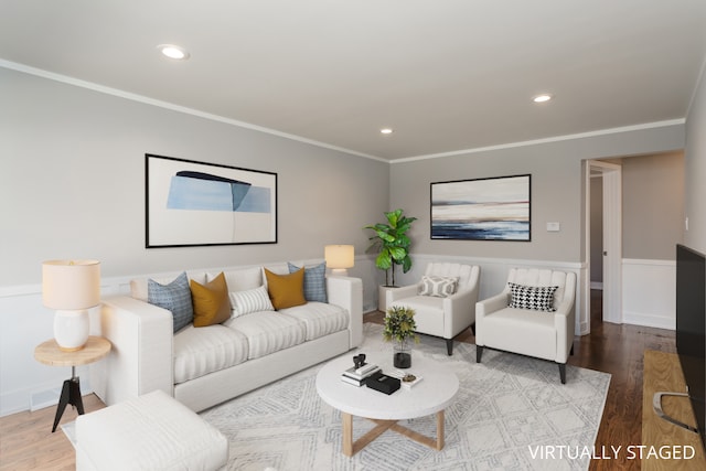 living room with hardwood / wood-style flooring and crown molding