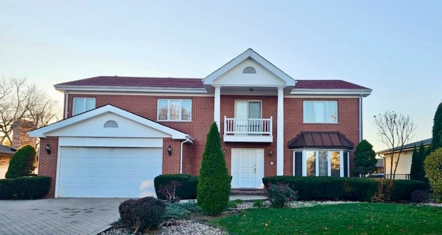 view of front of house featuring a garage and a balcony