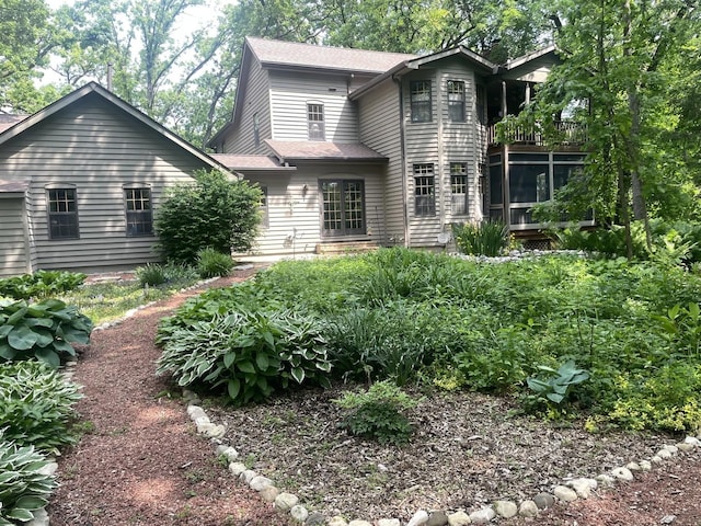 2418 Bennington Ln, Mchenry, IL 60050 - rear view of property with a balcony, a shingled roof, and a sunroom