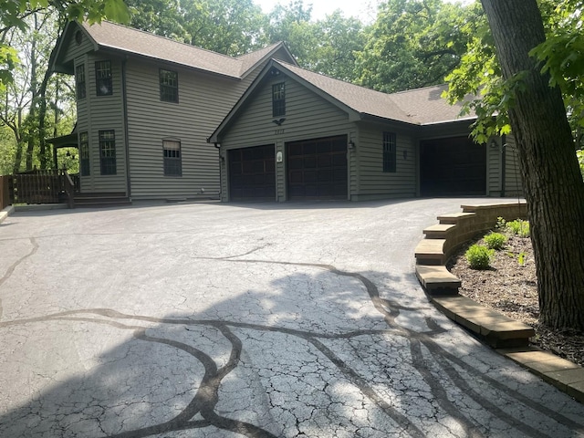 2418 Bennington Ln, Mchenry, IL 60050 - view of front of property featuring an attached garage, a shingled roof, and driveway