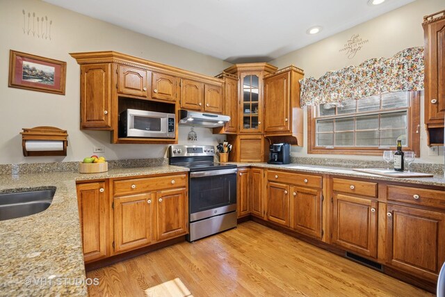 2418 Bennington Ln, Mchenry, IL 60050 - kitchen with stainless steel appliances, under cabinet range hood, brown cabinets, light wood-style floors, and recessed lighting