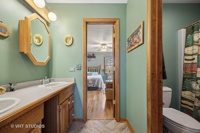 2418 Bennington Ln, Mchenry, IL 60050 - full bathroom featuring double vanity, toilet, connected bathroom, baseboards, and curtained shower