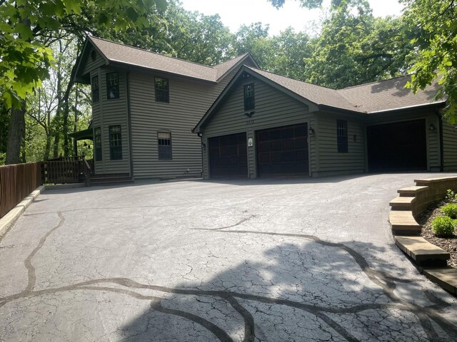 2418 Bennington Ln, Mchenry, IL 60050 - view of front of house with a garage, asphalt driveway, and a shingled roof
