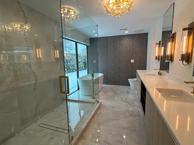 full bathroom with a notable chandelier, separate shower and tub, toilet, and vanity