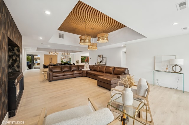 living room featuring light hardwood / wood-style floors and an inviting chandelier