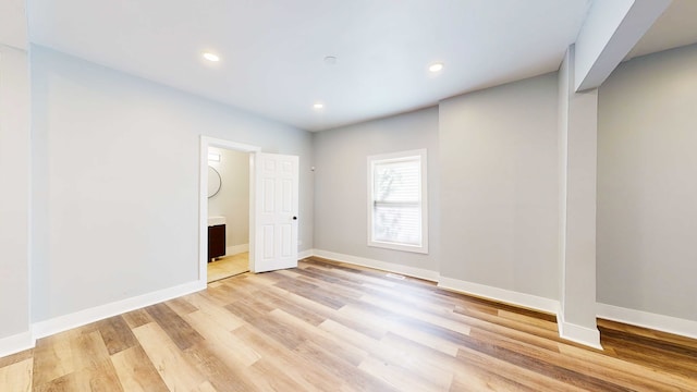 empty room with light hardwood / wood-style flooring