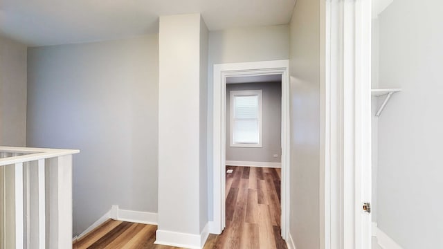 hall with hardwood / wood-style flooring