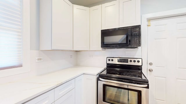 kitchen with backsplash, white cabinetry, and stainless steel range with electric cooktop