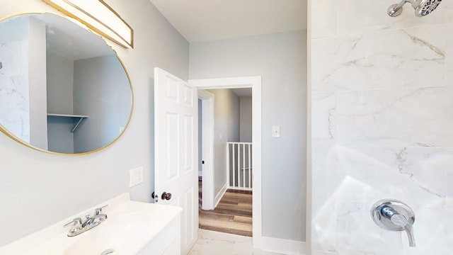 bathroom featuring a shower, sink, and hardwood / wood-style floors