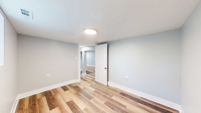 spare room with light hardwood / wood-style flooring