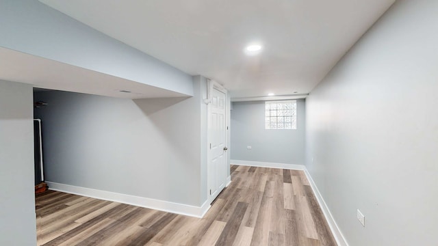 basement with light hardwood / wood-style floors