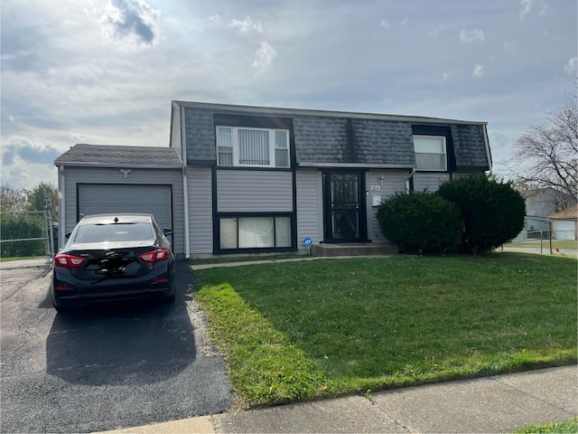 view of front facade with a garage and a front yard