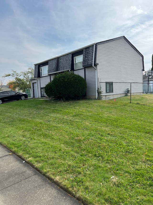 view of property exterior featuring a lawn