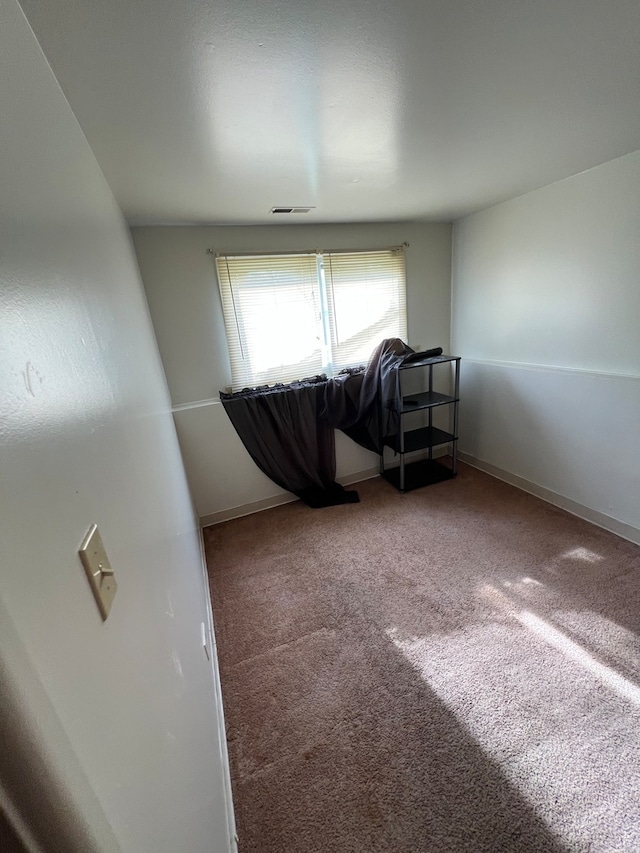 spare room featuring carpet