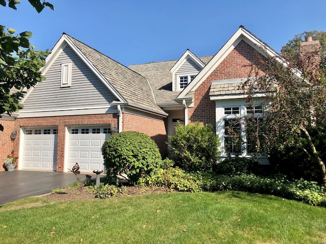 view of front of property featuring a garage and a front yard