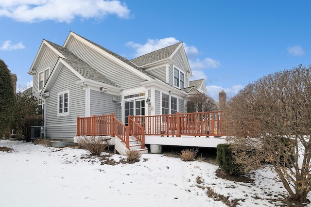 snow covered property featuring a wooden deck