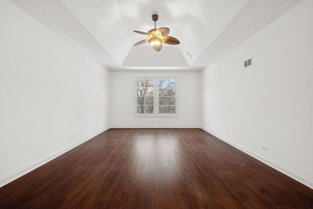 unfurnished room featuring a raised ceiling, ceiling fan, and dark wood-type flooring