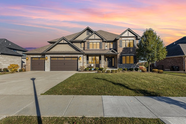 view of front of property with a garage and a yard