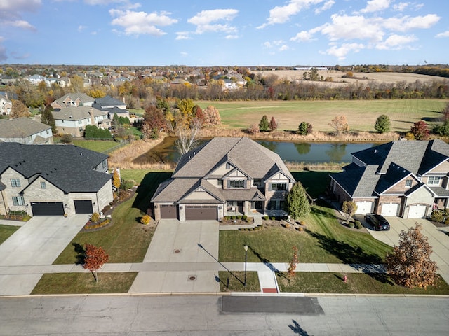 birds eye view of property with a water view