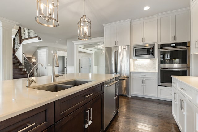 kitchen featuring white cabinets, stainless steel appliances, sink, and dark hardwood / wood-style flooring