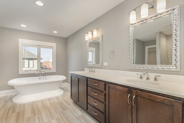 bathroom featuring vanity and a washtub