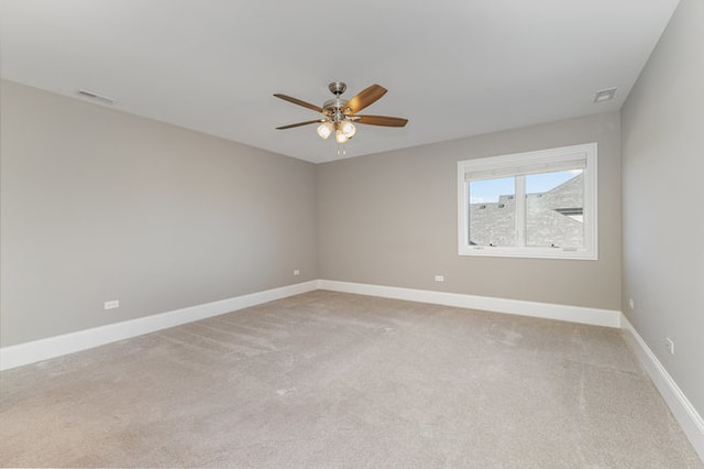 carpeted spare room with ceiling fan