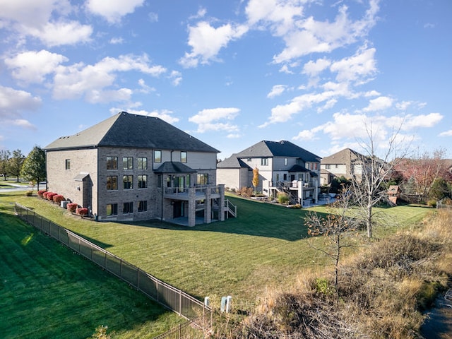 back of house featuring a lawn