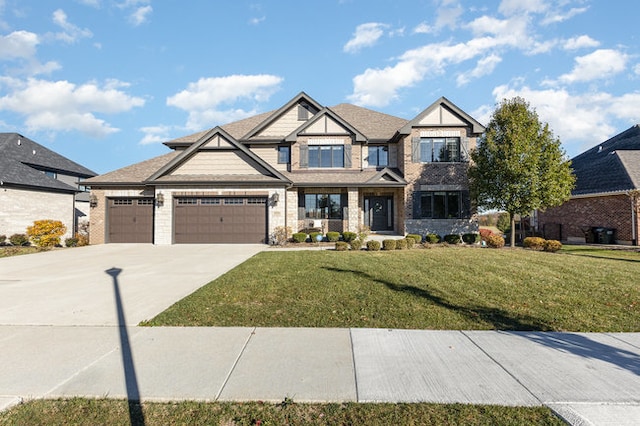 view of front of home with a garage and a front lawn