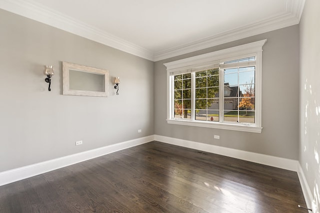 empty room featuring ornamental molding and dark hardwood / wood-style floors