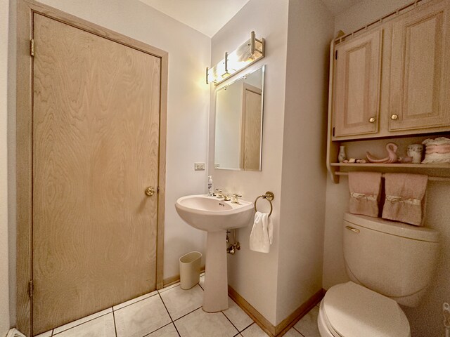 bathroom with toilet and tile patterned floors