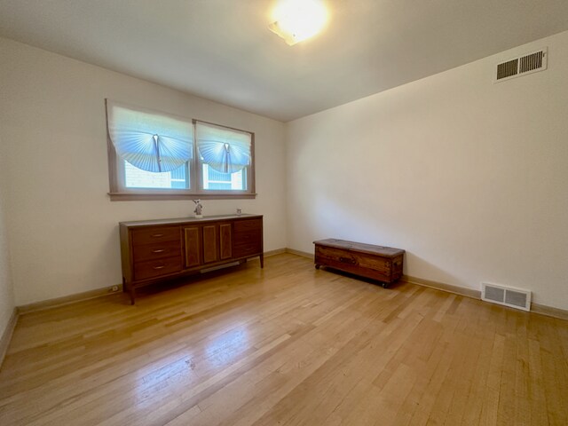 spare room with light wood-type flooring