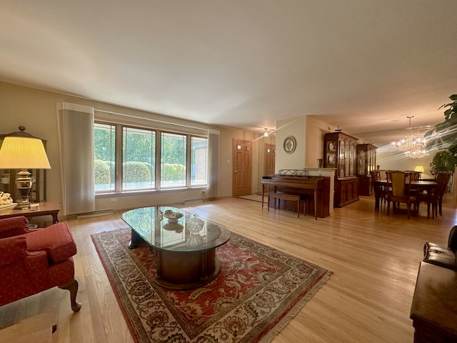 living room featuring light hardwood / wood-style flooring and a notable chandelier