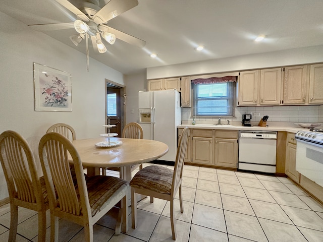 kitchen with light brown cabinetry, ceiling fan, light tile patterned floors, backsplash, and white appliances