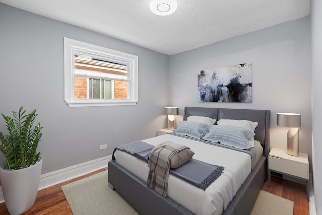 bedroom featuring a textured ceiling and dark wood-type flooring