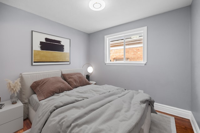 bedroom with hardwood / wood-style flooring